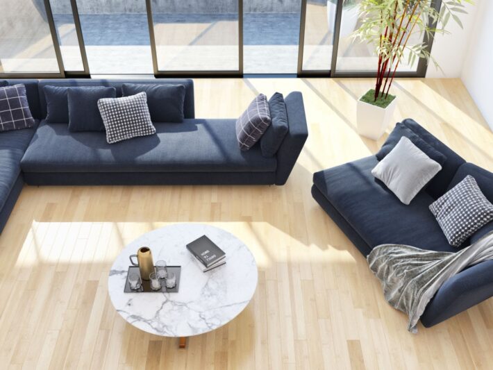 Tapicerowany narożnik wypoczynkowy w granatowym kolorze w nowoczesnym i przestronnym salonie